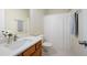 Clean bathroom with wood vanity, updated sink and shower with white shower curtain at 548 W Oaks Dr, Woodstock, GA 30188