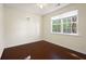 Inviting bedroom with wood flooring, a ceiling fan, and multiple windows for natural light at 548 W Oaks Dr, Woodstock, GA 30188