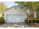 Charming single-Gathering home featuring an attached garage, manicured bushes, and a brick foundation at 548 W Oaks Dr, Woodstock, GA 30188