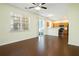 Open layout showcasing dark wood flooring and a kitchen equipped with modern stainless steel appliances at 548 W Oaks Dr, Woodstock, GA 30188