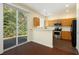 Bright kitchen featuring stainless steel appliances, granite countertops, and sliding glass doors for natural light at 548 W Oaks Dr, Woodstock, GA 30188