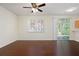 An airy living room with gleaming dark wood floors, natural lighting, and a sliding glass door at 548 W Oaks Dr, Woodstock, GA 30188
