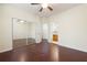 Bright main bedroom featuring hardwood floors, ceiling fan, and large closet with mirrored doors at 548 W Oaks Dr, Woodstock, GA 30188