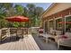 Back deck perfect for entertaining, featuring comfortable outdoor seating and a shady umbrella at 200 Sugar Mill Ln, Canton, GA 30115