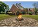 Beautiful backyard with a brick home, a firepit, and lush greenery, ideal for outdoor enjoyment at 200 Sugar Mill Ln, Canton, GA 30115