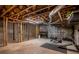 Unfinished basement featuring exposed wood beams, duct work, concrete walls and floor, and a home gym area at 200 Sugar Mill Ln, Canton, GA 30115