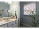 Neutral bathroom features a marble countertop, decorative sink, and window providing natural light at 200 Sugar Mill Ln, Canton, GA 30115