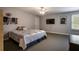Spacious bedroom with plush carpet, ceiling fan, and a large window for ample natural light at 200 Sugar Mill Ln, Canton, GA 30115