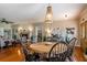 Hardwood floors flow throughout the dining room to the living room with a fireplace and large windows at 200 Sugar Mill Ln, Canton, GA 30115