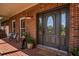 Elegant front door with glass accents provides a warm welcome to this brick home at 200 Sugar Mill Ln, Canton, GA 30115