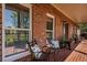 Inviting front porch with brick flooring and comfortable seating is perfect for relaxing outdoors at 200 Sugar Mill Ln, Canton, GA 30115