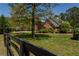 Beautifully landscaped front yard with mature trees, green lawn, and classic brick home at 200 Sugar Mill Ln, Canton, GA 30115