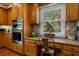 A kitchen desk area with granite countertop, wood cabinets, stainless appliances, and a view to the outside at 200 Sugar Mill Ln, Canton, GA 30115