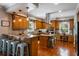 Spacious kitchen with wooden cabinets, granite countertops, island with breakfast bar and stainless steel appliances at 200 Sugar Mill Ln, Canton, GA 30115