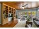 Sunroom-like living space with vaulted wood ceiling, built-in bookshelf, and natural light at 200 Sugar Mill Ln, Canton, GA 30115
