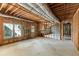 Unfinished basement with exposed wood framework, utilities, and natural light offering potential for customization at 1105 Westbrooke Ne Way, Brookhaven, GA 30319