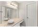 A white sink basin sits atop a granite countertop with a large mirror above at 1105 Westbrooke Ne Way, Brookhaven, GA 30319