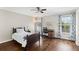 This cozy bedroom has hardwood floors, neutral paint, a ceiling fan, and a great window view to the outdoors at 1105 Westbrooke Ne Way, Brookhaven, GA 30319