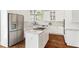 Bright kitchen with stainless steel refrigerator, granite counters, and white cabinets at 1105 Westbrooke Ne Way, Brookhaven, GA 30319