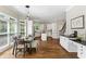 Bright kitchen with white cabinets, a center island, and a dining area with hardwood floors at 1105 Westbrooke Ne Way, Brookhaven, GA 30319