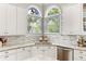 Kitchen features granite countertops, stainless steel appliances, and lovely accent windows at 1105 Westbrooke Ne Way, Brookhaven, GA 30319
