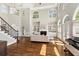Grand living room with a fireplace, built-in shelves, and hardwood floors and lots of natural light at 1105 Westbrooke Ne Way, Brookhaven, GA 30319