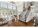 Spacious living room with hardwood floors, large windows, fire place and staircase to second floor at 1105 Westbrooke Ne Way, Brookhaven, GA 30319