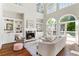 Comfortable living room featuring built-in shelves, a fireplace, and access to the back patio at 1105 Westbrooke Ne Way, Brookhaven, GA 30319