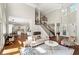 Open-concept living room with hardwood floors, staircase, and large windows bringing in lots of light at 1105 Westbrooke Ne Way, Brookhaven, GA 30319