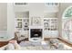 Cozy living room showcasing a fireplace, hardwood floors, and custom built-in shelving at 1105 Westbrooke Ne Way, Brookhaven, GA 30319