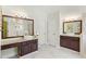 The primary bathroom has a long granite countertop with double sinks and wooden cabinets at 1105 Westbrooke Ne Way, Brookhaven, GA 30319