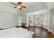 Large primary bedroom with lots of natural light, tray ceilings, and hardwood flooring at 1105 Westbrooke Ne Way, Brookhaven, GA 30319
