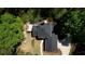 Aerial view showcases the roof, a deck, and landscaped areas surrounding the home at 1660 Weems Rd, Locust Grove, GA 30248
