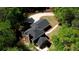 Aerial view features house, driveway, and landscaping nestled among mature trees, offering privacy at 1660 Weems Rd, Locust Grove, GA 30248