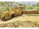 Backyard of home featuring an elevated deck overlooking a lush green yard at 1660 Weems Rd, Locust Grove, GA 30248