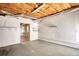 Unfinished basement with exposed insulation and shelving, offering potential for customization at 1660 Weems Rd, Locust Grove, GA 30248
