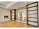 An unfurnished basement featuring hardwood floors and built-in bookcases at 1660 Weems Rd, Locust Grove, GA 30248
