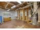 Unfinished basement featuring exposed plumbing and beams, ready for your customizations at 1660 Weems Rd, Locust Grove, GA 30248