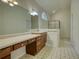 Large bathroom features makeup vanity, tile floors, and large mirror at 1660 Weems Rd, Locust Grove, GA 30248