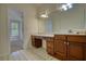 Bathroom features double vanity, tile floors and large mirror at 1660 Weems Rd, Locust Grove, GA 30248