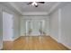 Bright bedroom with wood floors and a double mirrored closet, ready for personalization at 1660 Weems Rd, Locust Grove, GA 30248