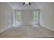 Spacious bedroom featuring a double window, closet, and neutral carpeting at 1660 Weems Rd, Locust Grove, GA 30248