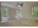Bedroom features large windows, ceiling fan, carpet and neutral paint at 1660 Weems Rd, Locust Grove, GA 30248