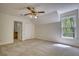 Bright bedroom with a window and closet; bathroom is accessible from the bedroom at 1660 Weems Rd, Locust Grove, GA 30248
