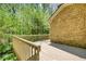Wooden deck overlooking a lush, green yard and mature trees of the property at 1660 Weems Rd, Locust Grove, GA 30248
