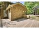 Wooden deck of the home with an exterior door and landscaped yard at 1660 Weems Rd, Locust Grove, GA 30248