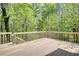 Expansive wooden deck surrounded by lush greenery, offering outdoor living space at 1660 Weems Rd, Locust Grove, GA 30248