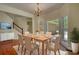 Dining room complete with wood floors, chandelier and a view to the home's backyard at 1660 Weems Rd, Locust Grove, GA 30248