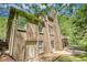 Brick home's exterior features a walkout basement, lush yard, and a second story deck at 1660 Weems Rd, Locust Grove, GA 30248