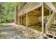 Two-story deck of brick home with stone landscaping and a lush backyard at 1660 Weems Rd, Locust Grove, GA 30248